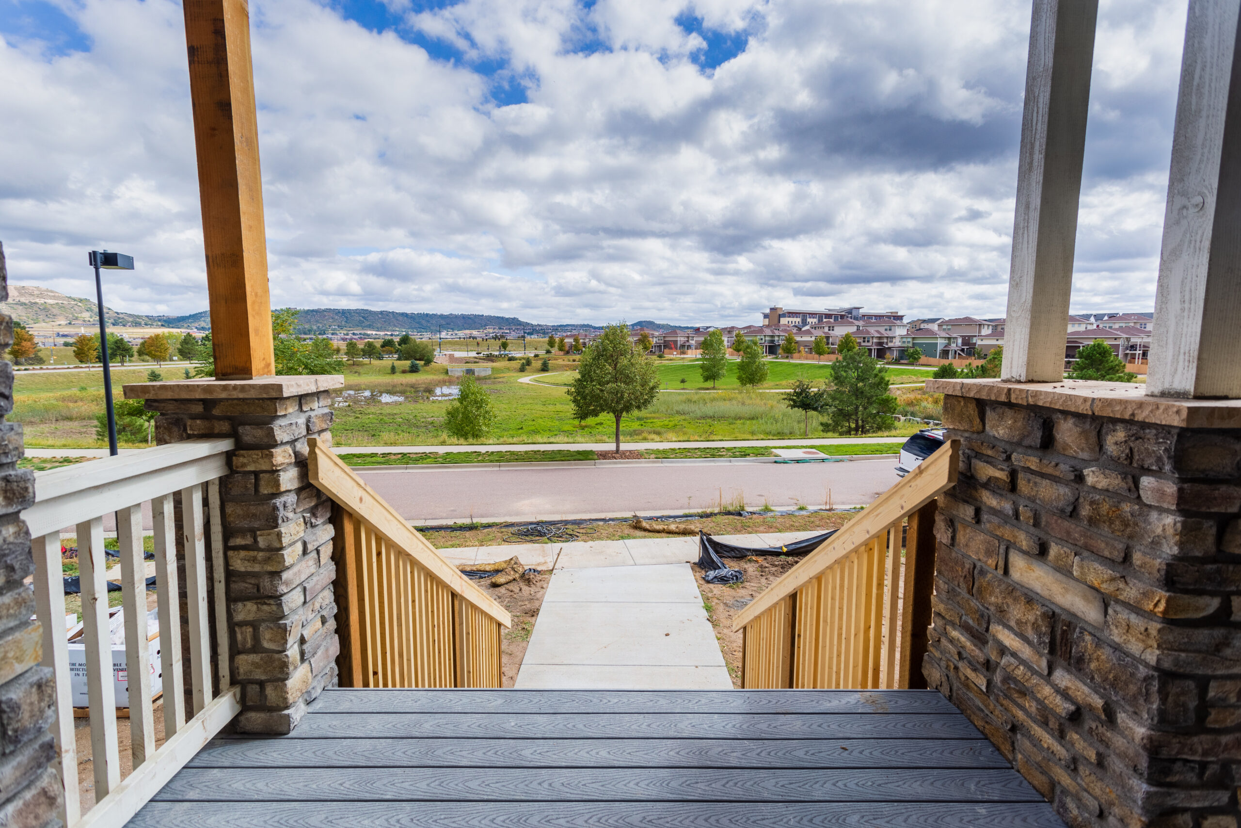 Front steps leading down to a mountain and prairie vista on the Colorado front range