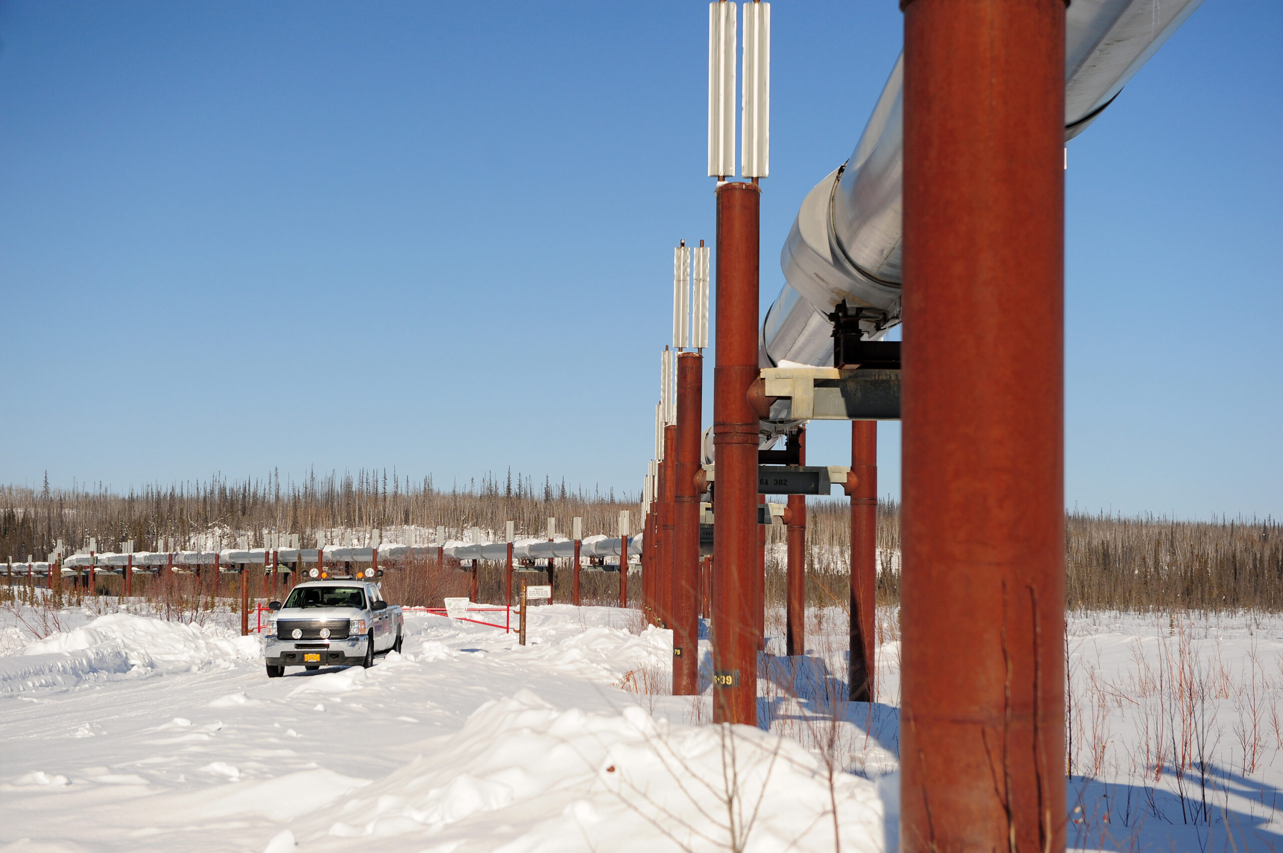 a service truck with alaska oil pipeline in winter